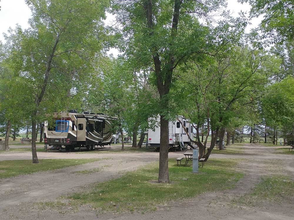 Campsites with parked RVs in distance at GRAND FORKS CAMPGROUND