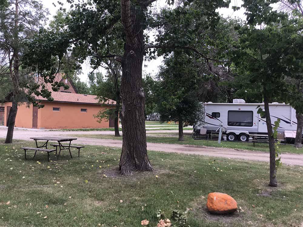 Campsite with RV in distance at GRAND FORKS CAMPGROUND