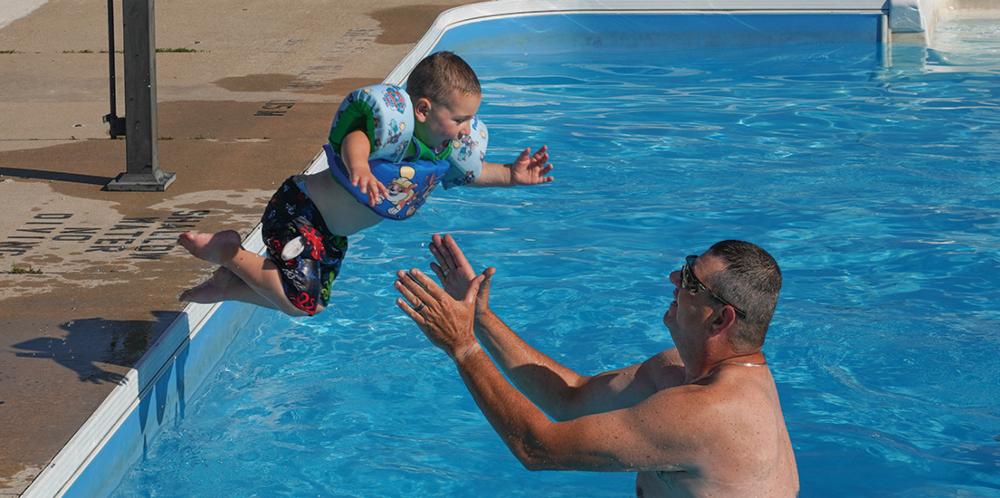 A child jumping into the pool