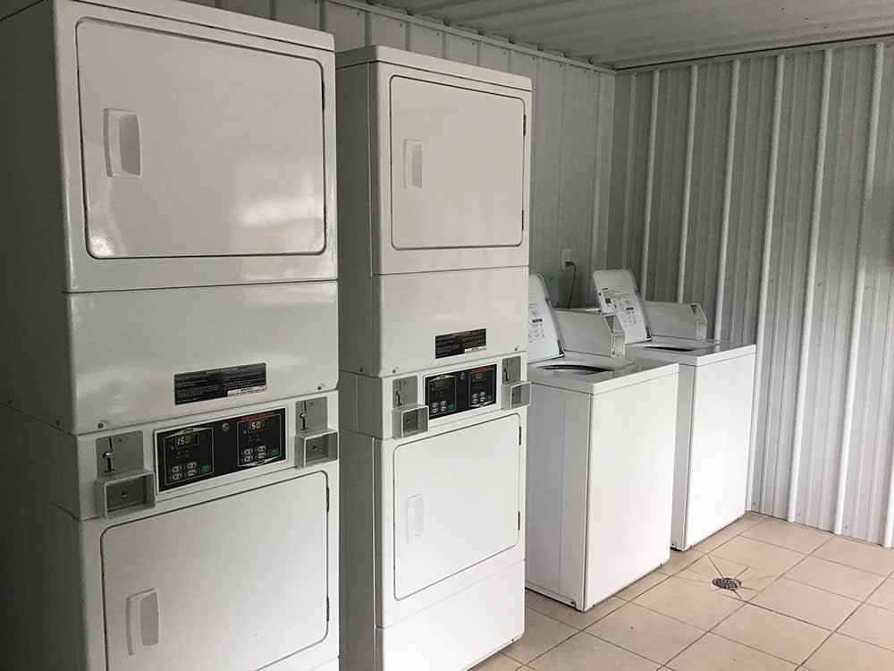A group of washing machines and dryers at BOOTHEEL RV PARK & EVENT CENTER