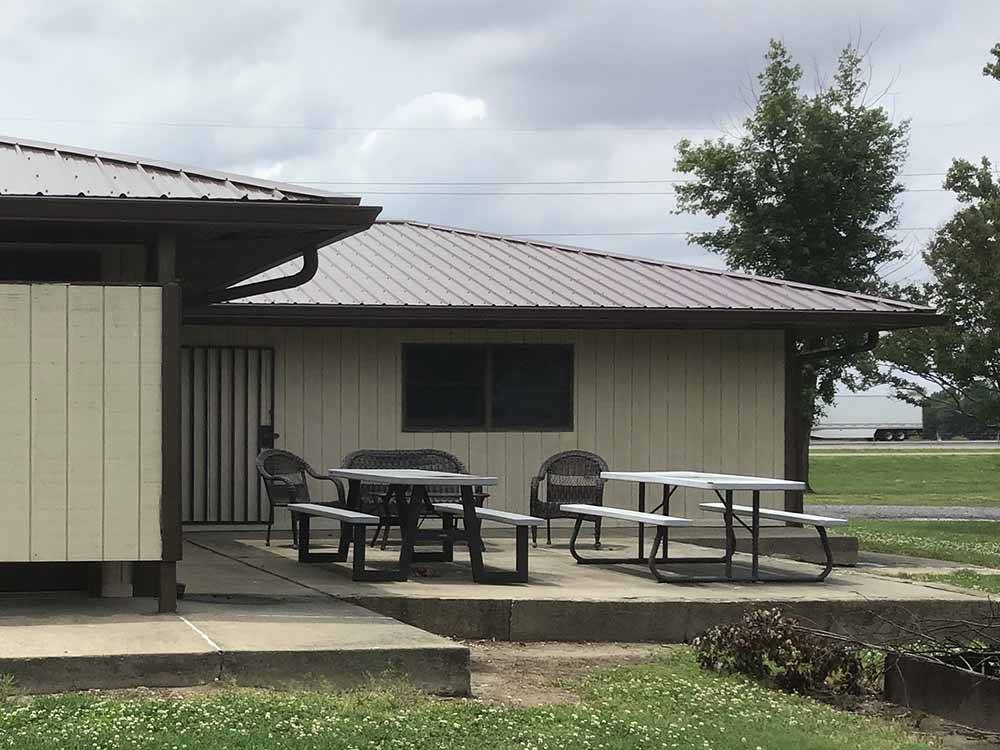 A couple of picnic tables outside of the main building at BOOTHEEL RV PARK & EVENT CENTER
