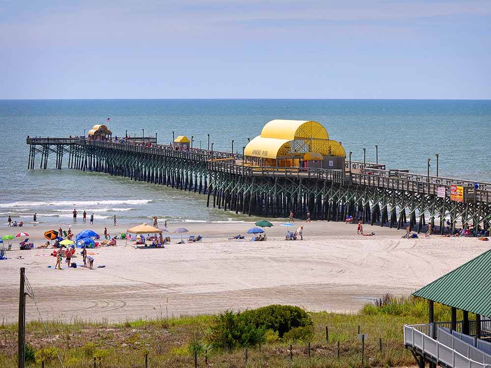 The people on the beach and pier at APACHE FAMILY CAMPGROUND & PIER