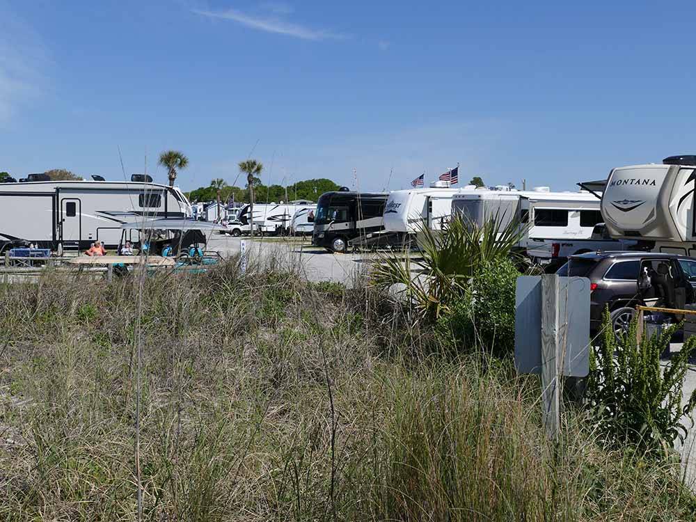 A row of paved RV sites at APACHE FAMILY CAMPGROUND & PIER