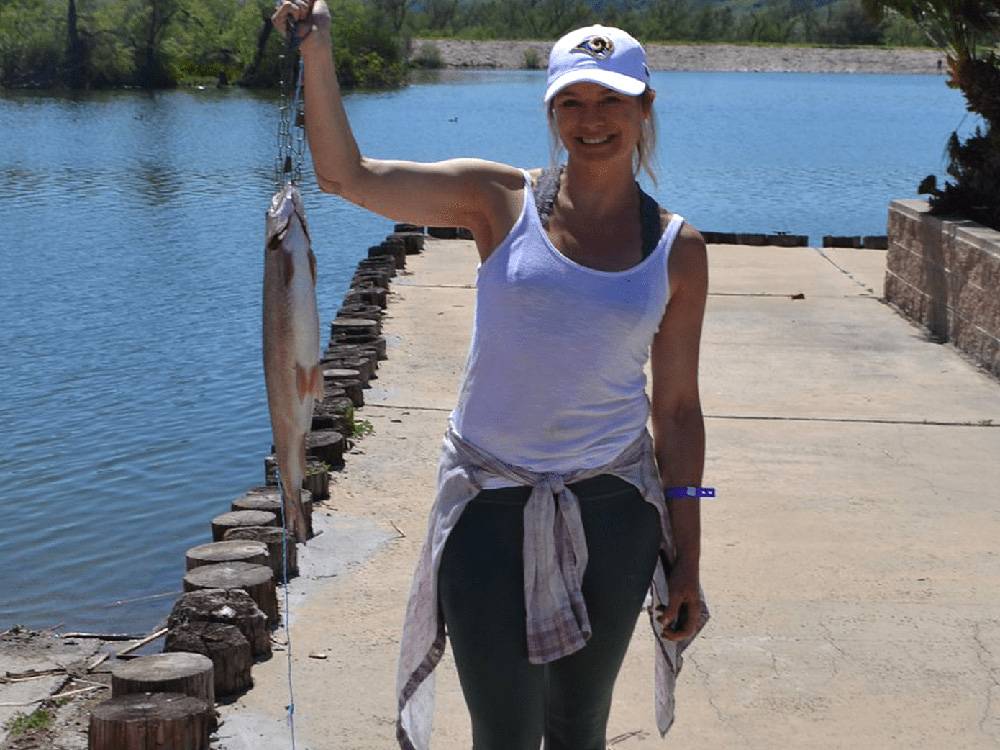 Woman holding fish she caught
