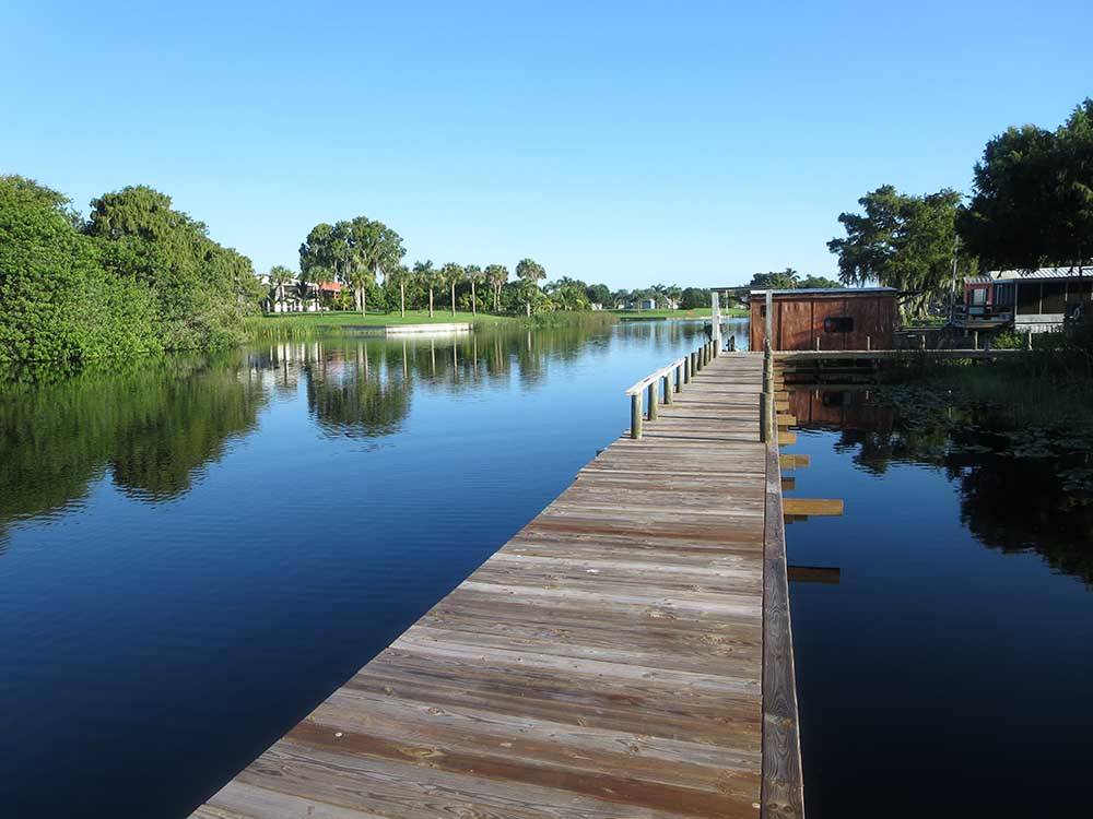A long, wooden pier on the water at ZACHARY TAYLOR WATERFRONT RV RESORT
