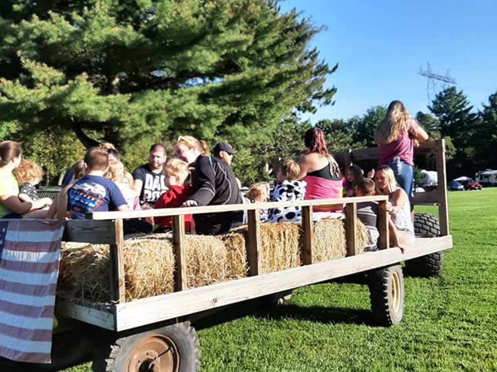 A group of people on a hay ride at COUNTRY ROADS CAMPGROUND