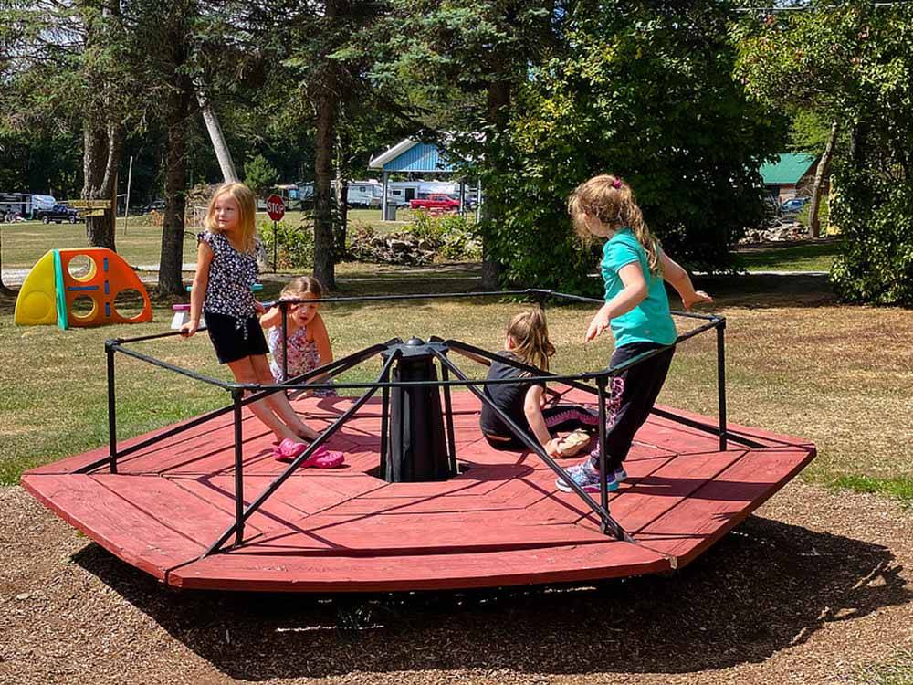 Kids on a merry go round at COUNTRY ROADS CAMPGROUND