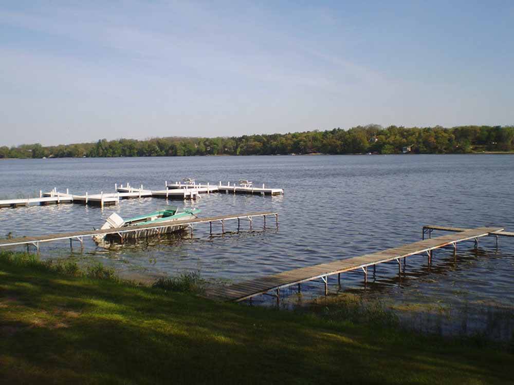 Three boat docks on a lake at BUFFALO LAKE CAMPING RESORT