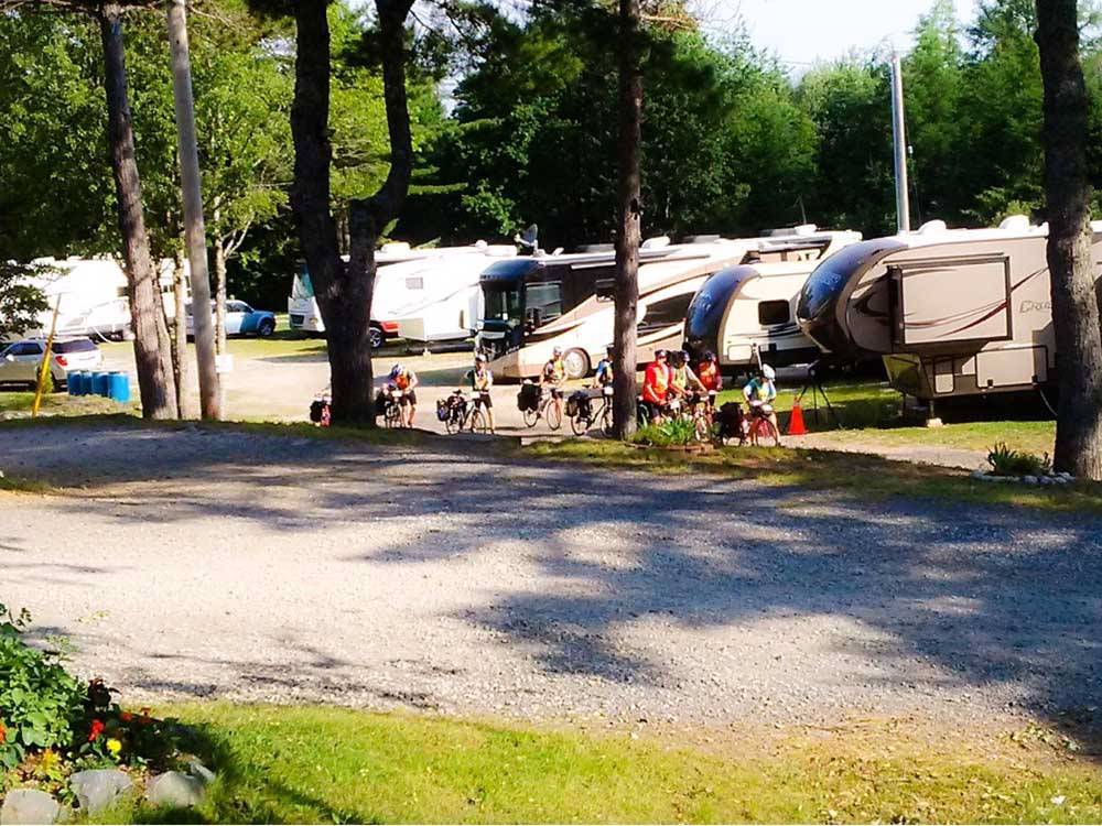 Campers gathered at a green RV campground at RAYPORT CAMPGROUND