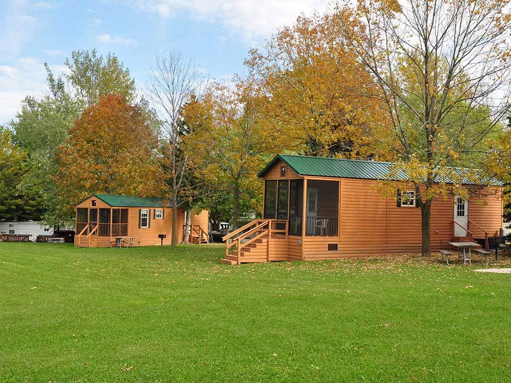 Log cabins with decks at PLYMOUTH ROCK CAMPING RESORT