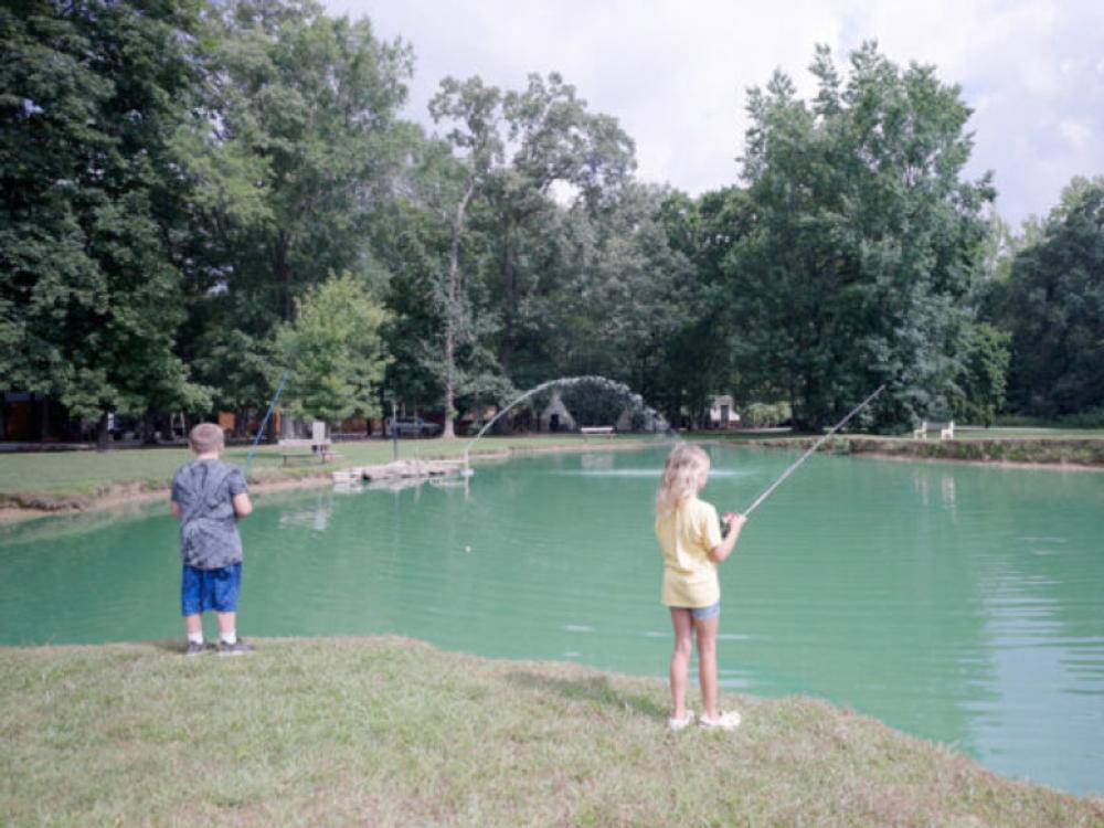 Kids fishing in the pond at The Broken Banjo RV Park