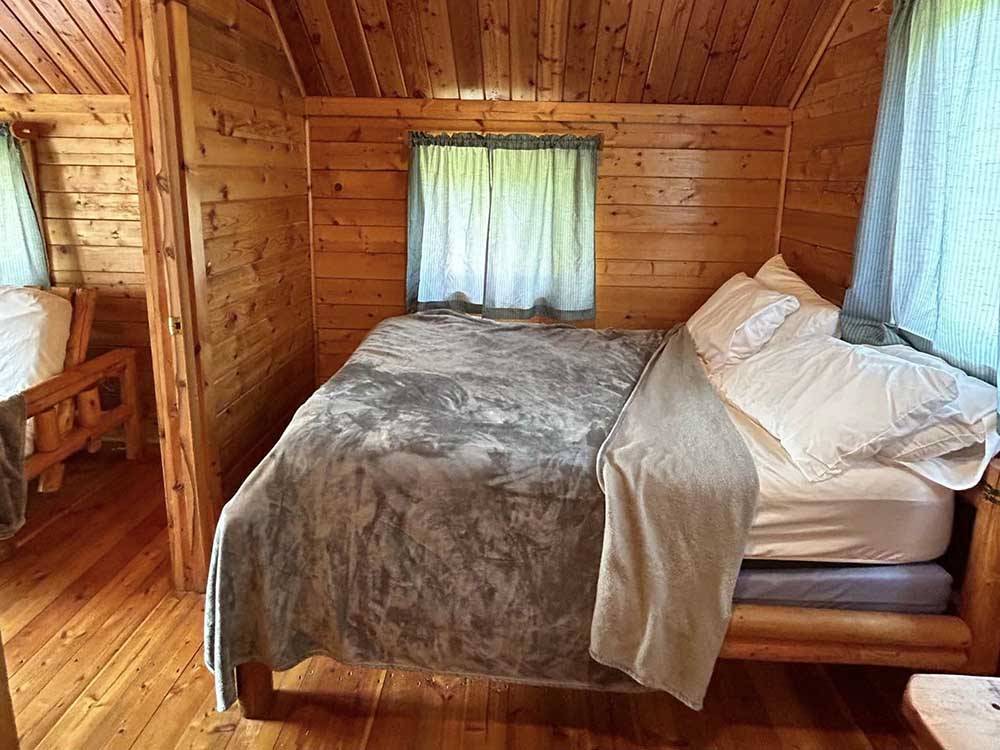 The bed in the cabin rental at MERAMEC CAMPGROUND