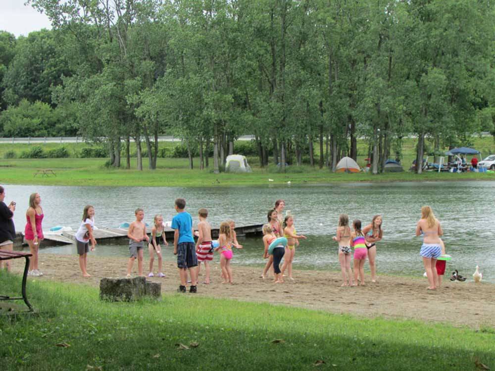 Kids playing egg toss along the shore at ENON BEACH CAMPGROUND