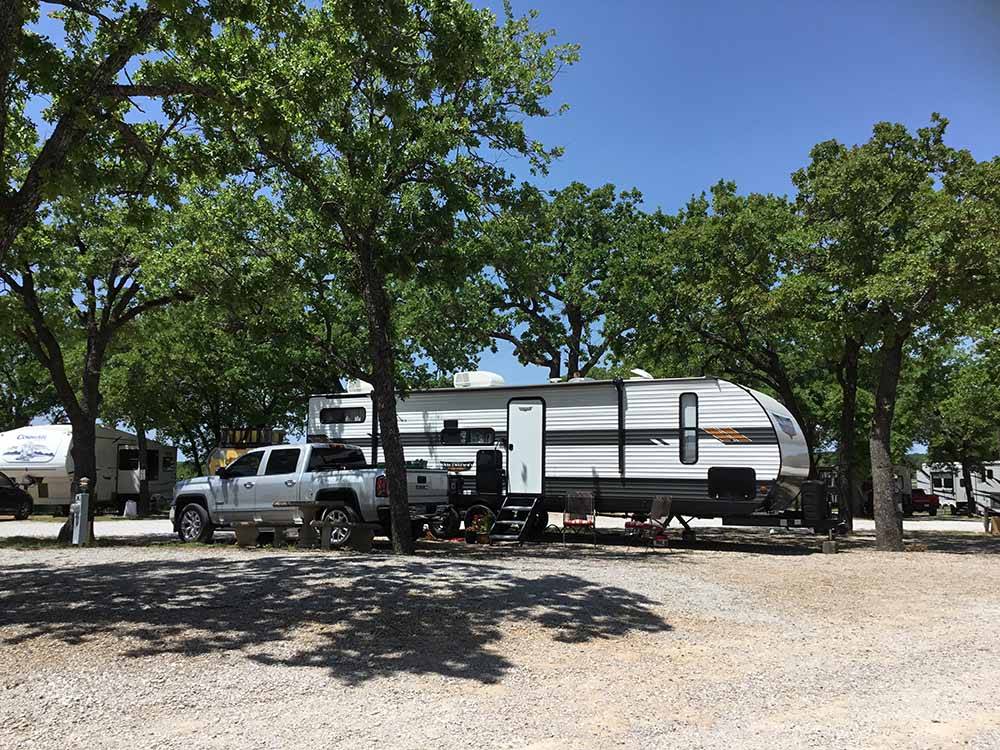 A travel trailer in an RV site at CAMPER'S PARADISE RV PARK