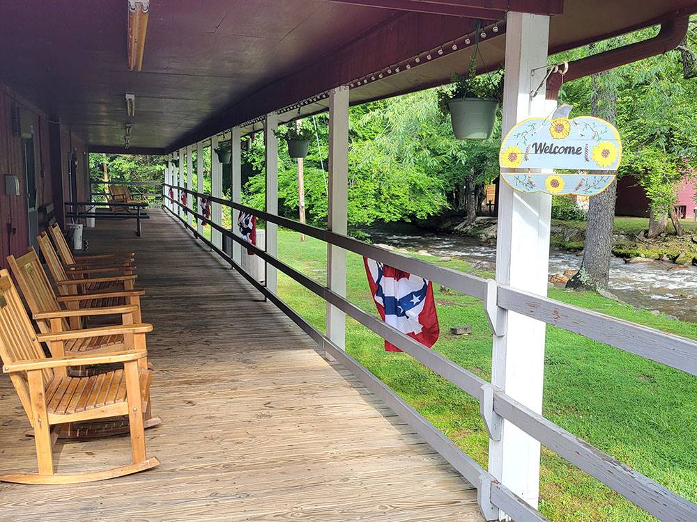 Porch with wooden rocking chairs at Happy Holiday Campground