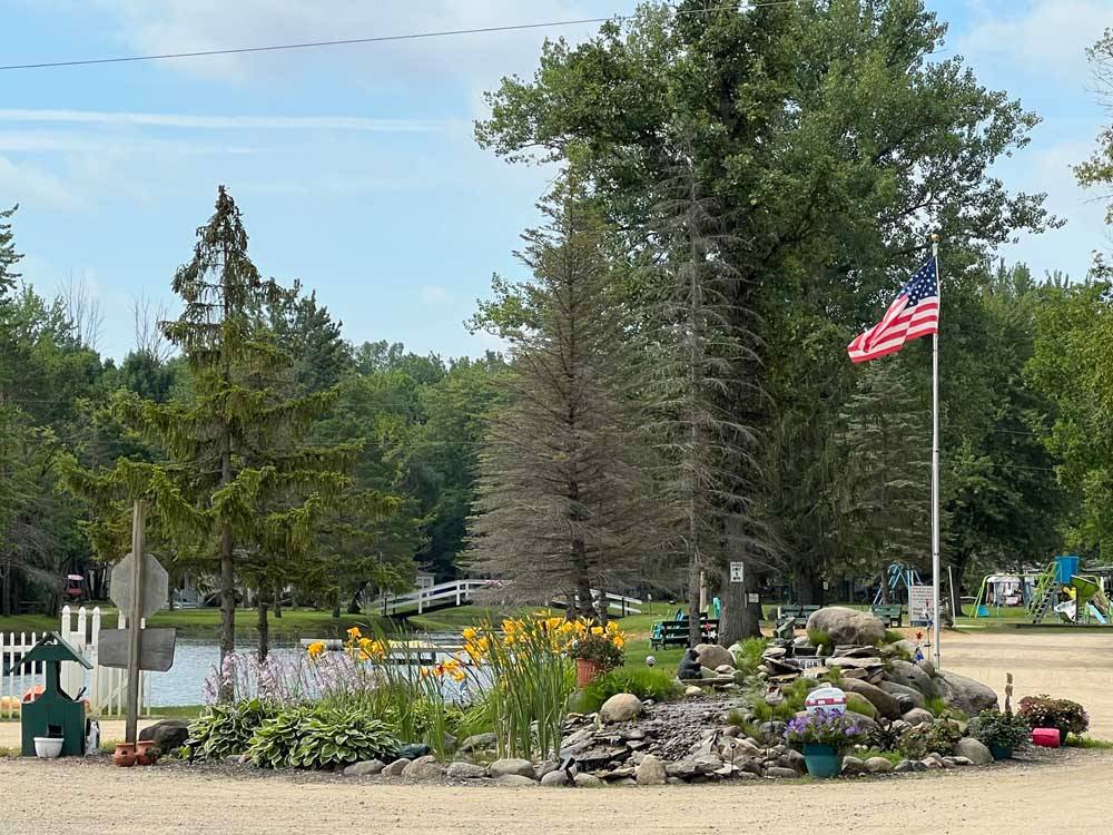 Landscaped area with American flag at BER WA GA NA CAMPGROUND