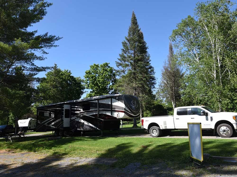 A truck and fifth wheel parked in a RV site at GREAT CANADIAN RESORTS & CAMPGROUNDS