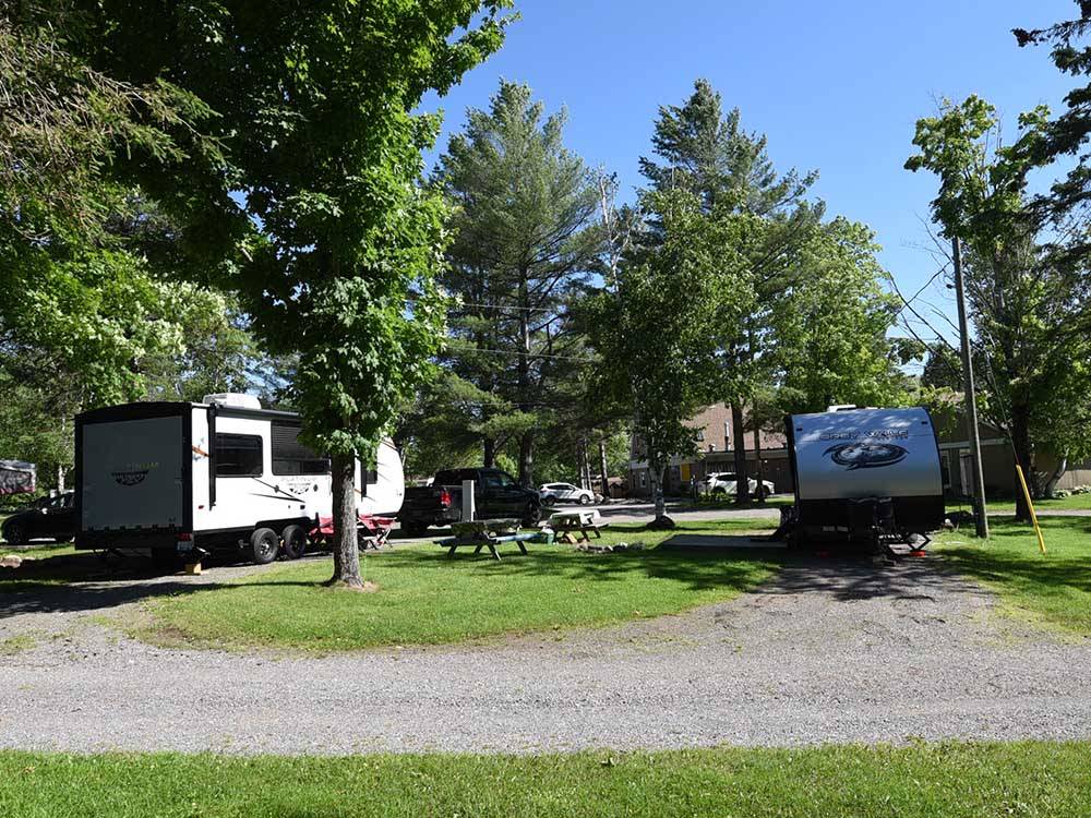 Two trailers parked in gravel sites at GREAT CANADIAN RESORTS & CAMPGROUNDS