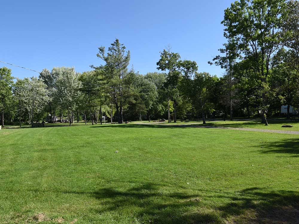 A large, green grassy area at GREAT CANADIAN RESORTS & CAMPGROUNDS