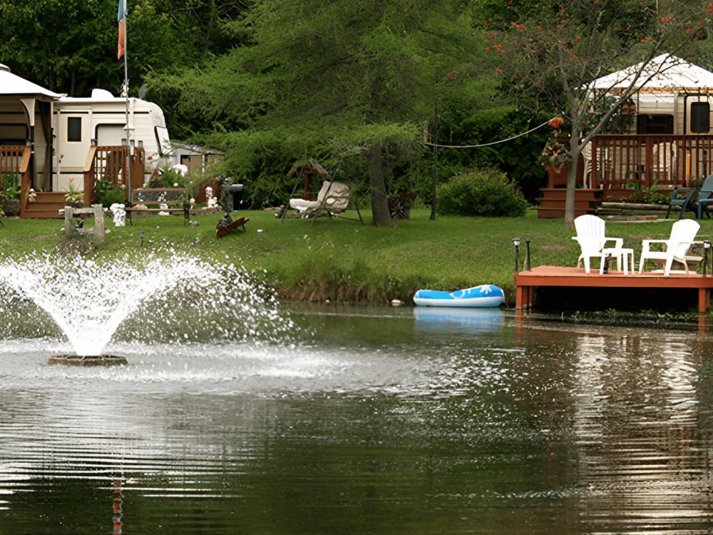 A dock with chairs and RVs in the background