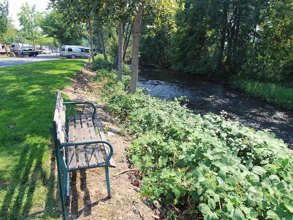 A park bench looking at the stream at HOLIDAY RV PARK