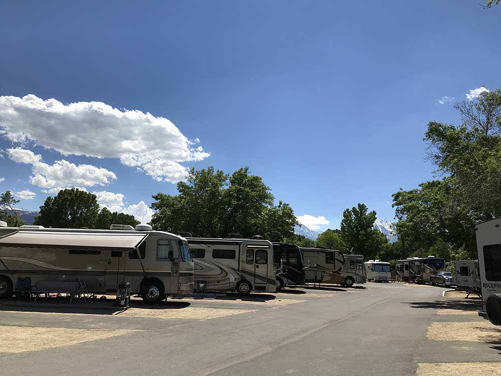 Big rigs parked in paved pads at HIGHLANDS RV PARK