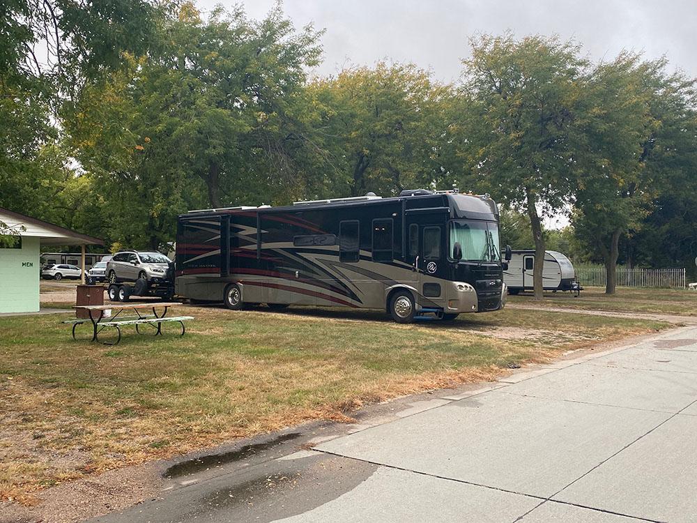 Large RV in site at PIONEER VILLAGE CAMPGROUND