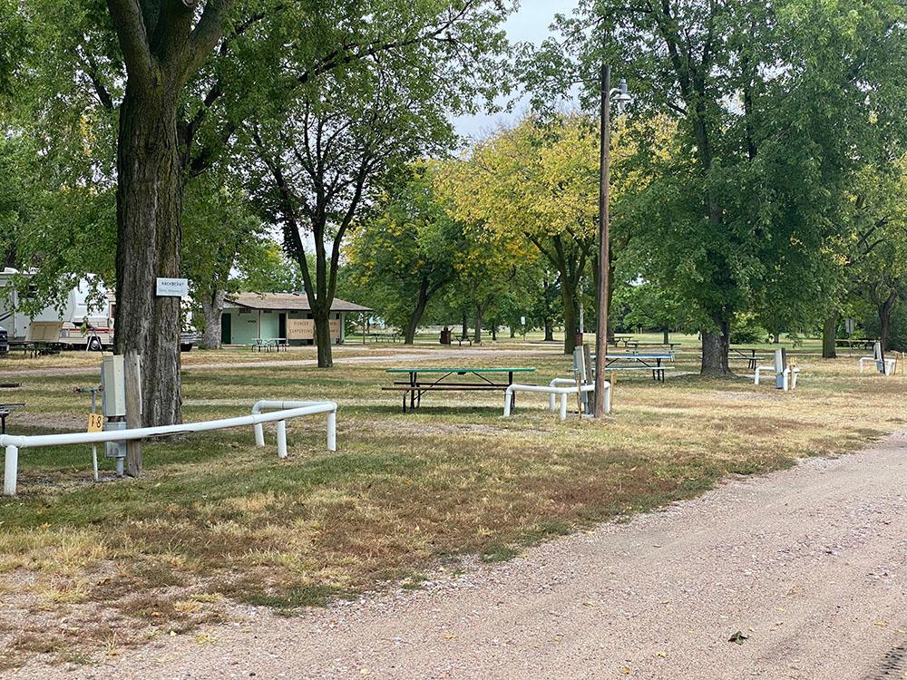 Sites with tables and white rails at PIONEER VILLAGE CAMPGROUND