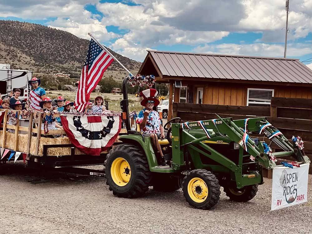 A group of people on a hay ride at ASPEN RIDGE RV PARK