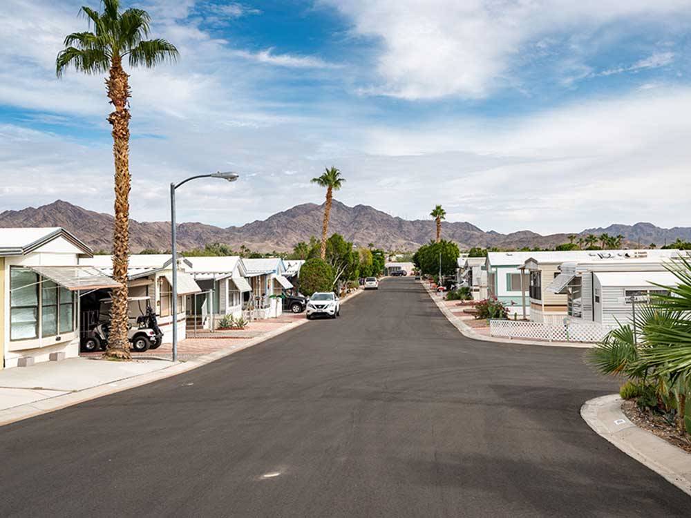A paved road between the mobile homes at SUNDANCE RV RESORT