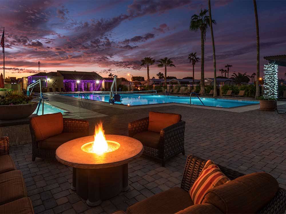 The fire pits by the swimming pool at night at SUNDANCE RV RESORT