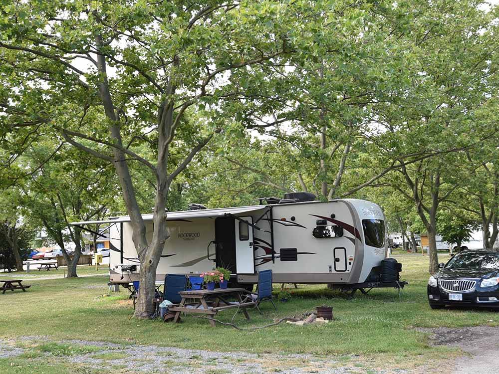 A travel trailer under some trees at SCOTT'S FAMILY RV-PARK CAMPGROUND