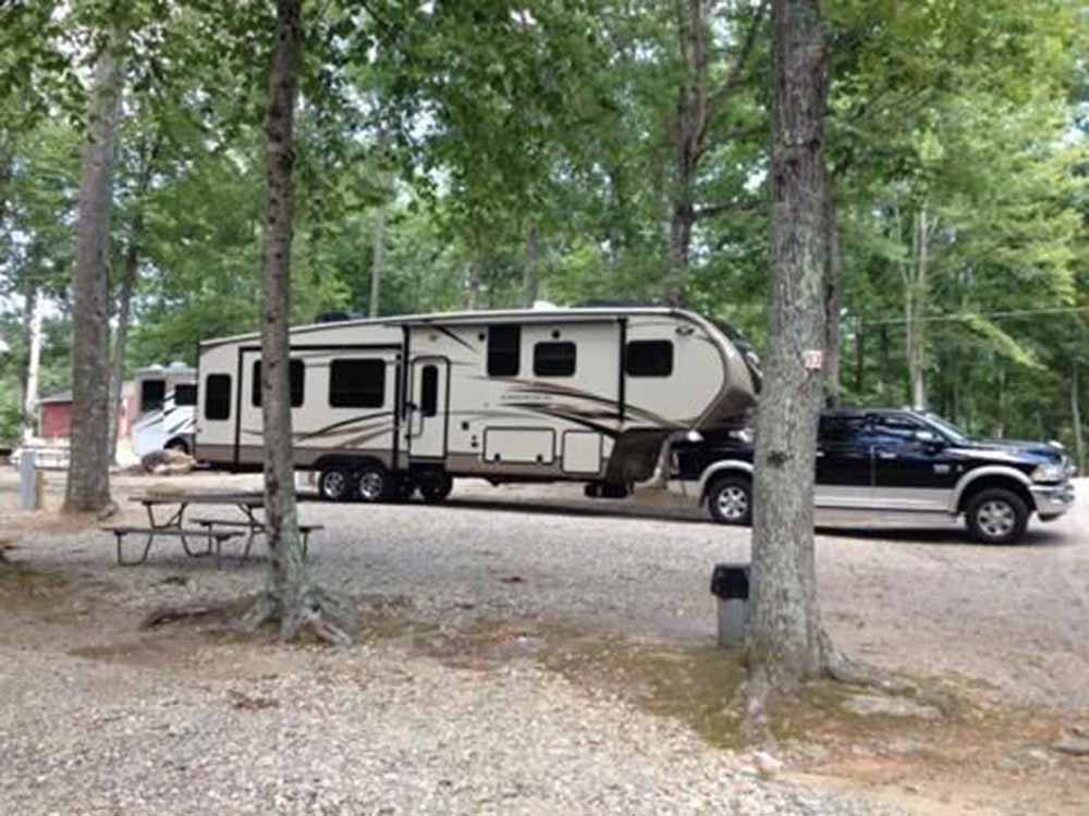 A fifth wheel trailer in a gravel RV site at SALEM FARMS CAMPGROUND