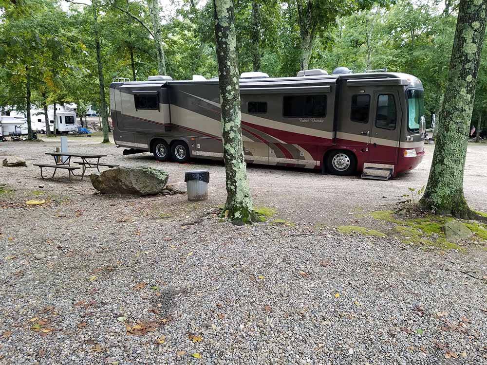 A motorcoach in a gravel RV site at SALEM FARMS CAMPGROUND