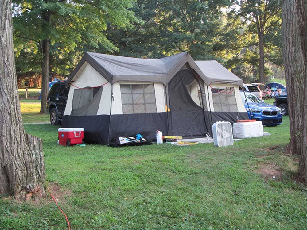 A large tent set up at a campsite at HICKORY RUN CAMPGROUND