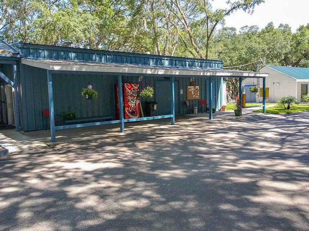 A soda vending machine in front of the building at HAPPY TRAVELER RV RESORT