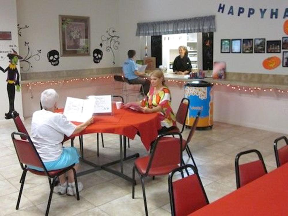 Interior eating area with tables and chairs at HAPPY TRAVELER RV RESORT