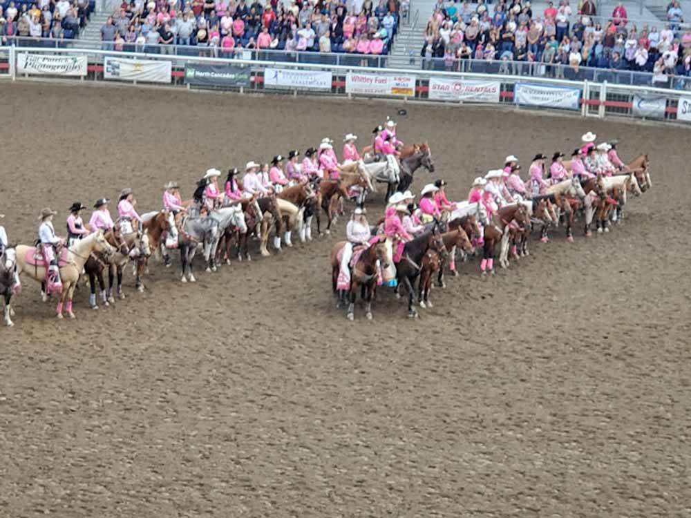 Ladies dressed in pink on horses nearby at CARL PRECHT MEMORIAL RV PARK
