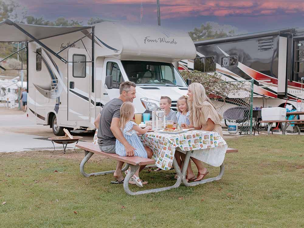 A family eating at a picnic table at NEWPORT DUNES WATERFRONT RESORT & MARINA