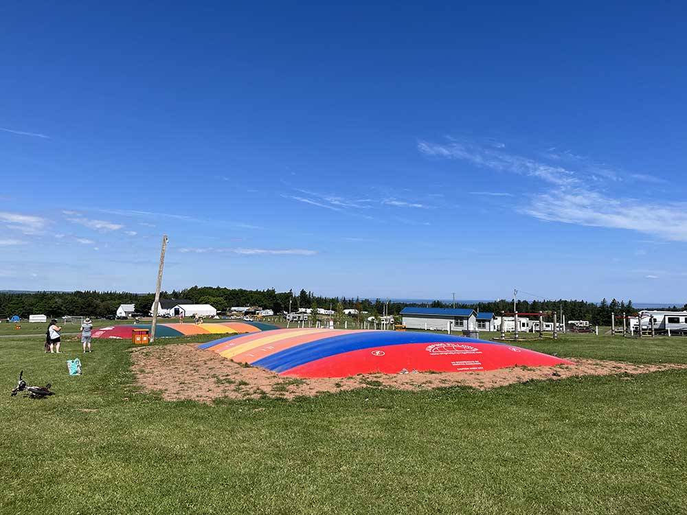 Two jumping pillows in a field at MARCO POLO LAND