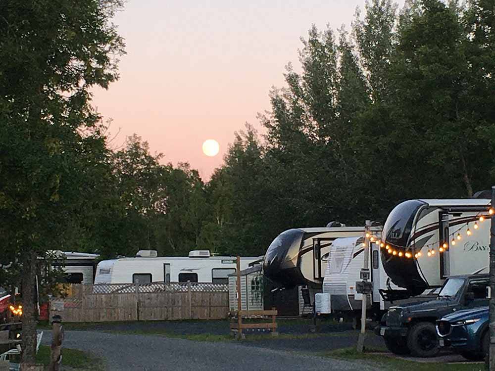 A group of trailers in RV sites at CAMPING PANORAMIC