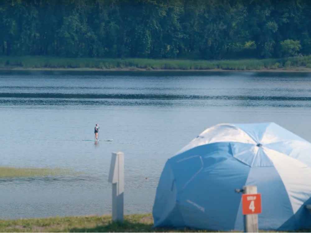 A tent site by the water at HARTT ISLAND RV RESORT & WATERPARK