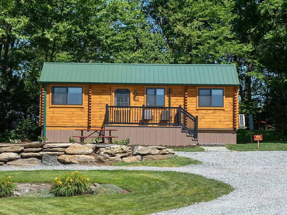 Exterior view of a cabin with porch at COUNTRY ACRES CAMPGROUND