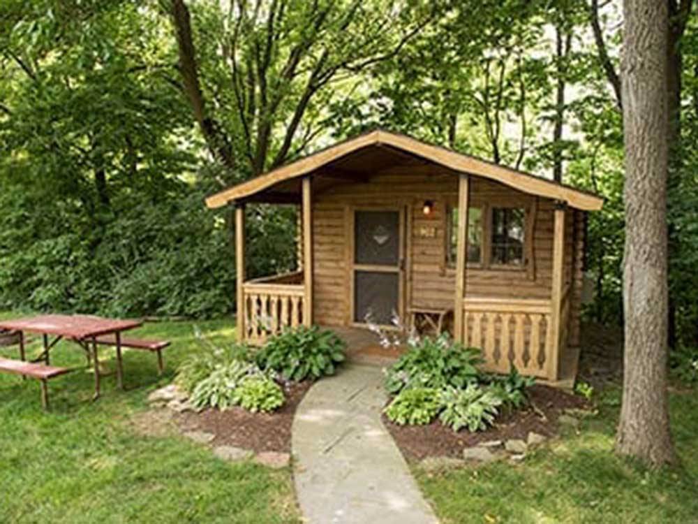 Camping cabin with log-cabin exterior at COUNTRY ACRES CAMPGROUND