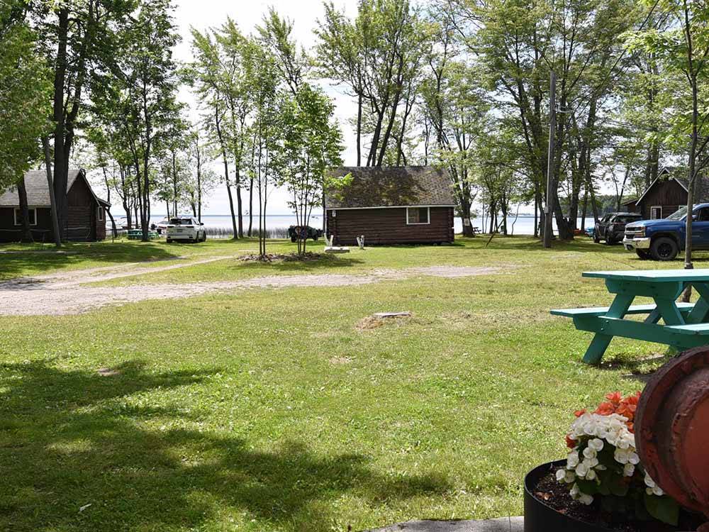 A grassy RV site with a picnic table at GLENROCK COTTAGES & TRAILER PARK