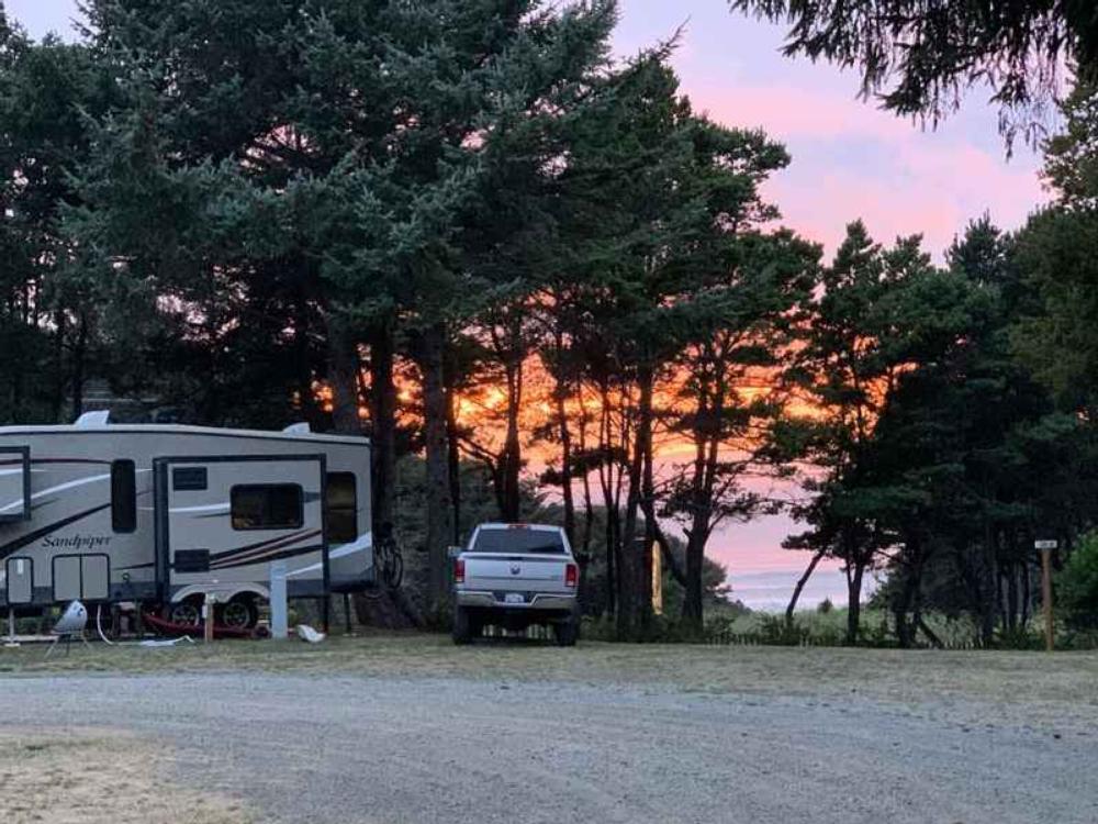 5th wheel in RV site at sunset at Honey Bear By the Sea RV Resort