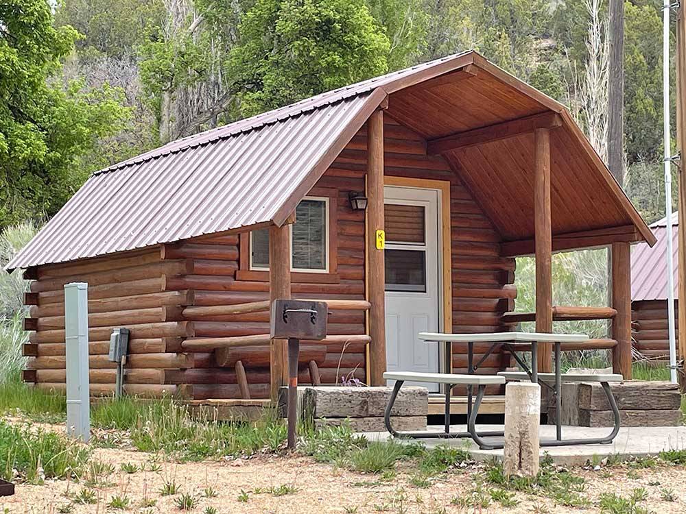 One of the rustic rental log cabins at BRYCE-ZION CAMPGROUND