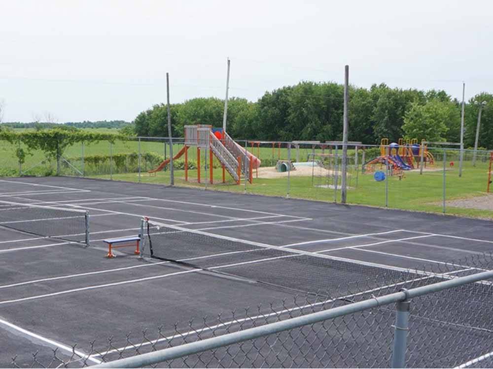 The pickleball court and playground at CAMPING DU VIEUX MOULIN, ENR.199780