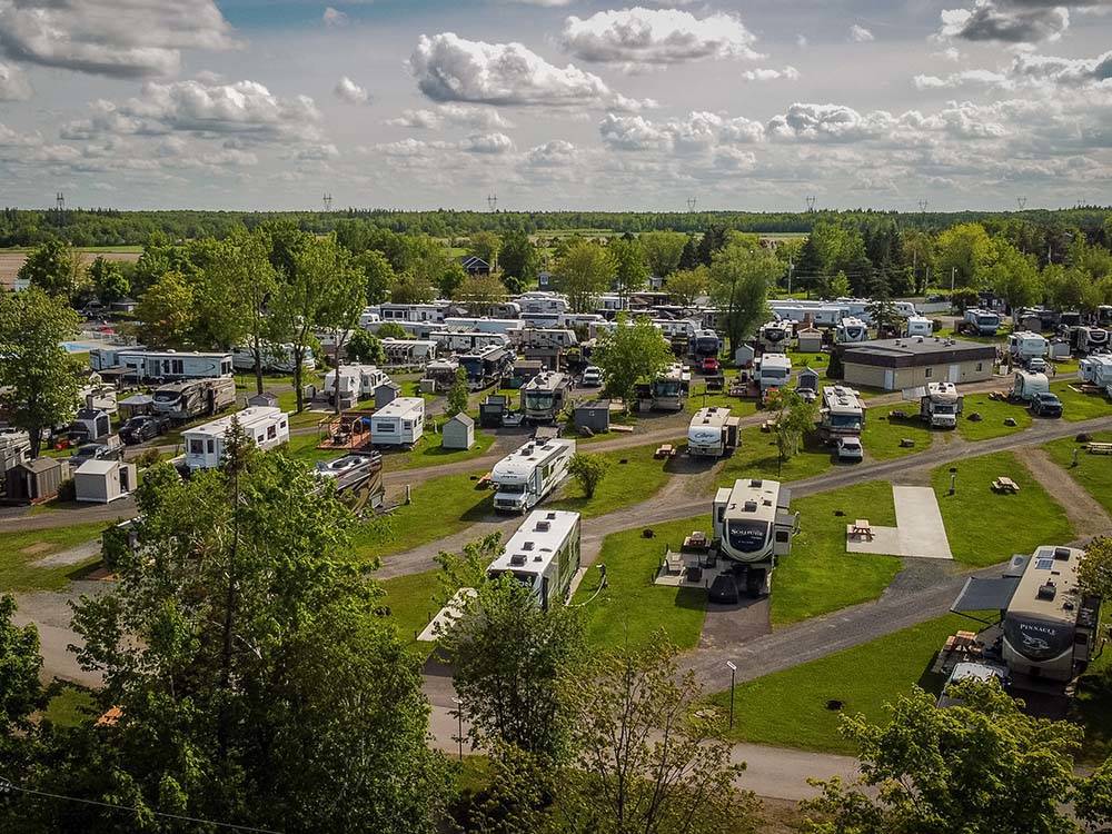 Aerial view of RVs on paved lots with green belts at CAMPING TRANSIT, ENR.205155