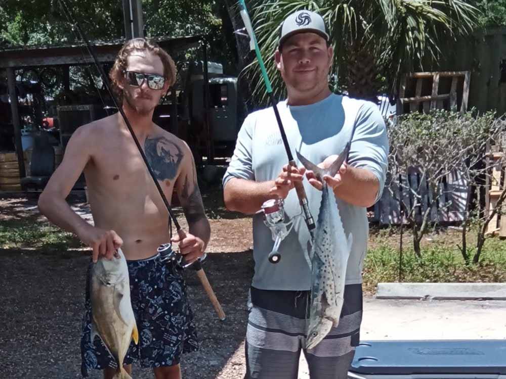 Two men holding fish they caught at VERO BEACH KAMP